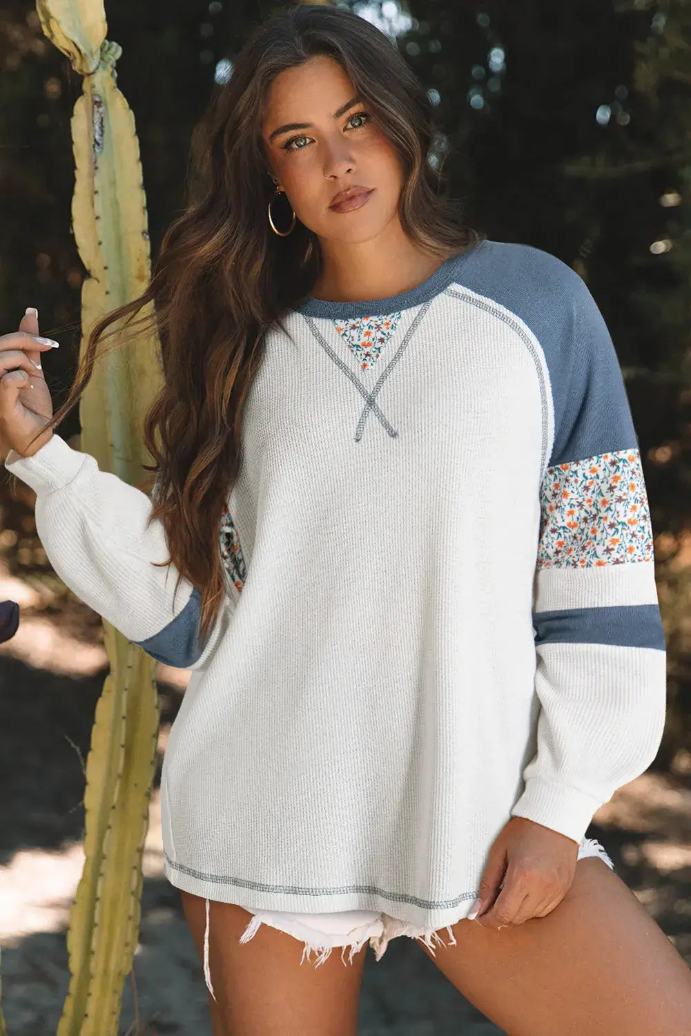 Model wearing the Serene Skies Top, featuring boho floral patchwork and a relaxed fit, perfect for casual chic outfits.