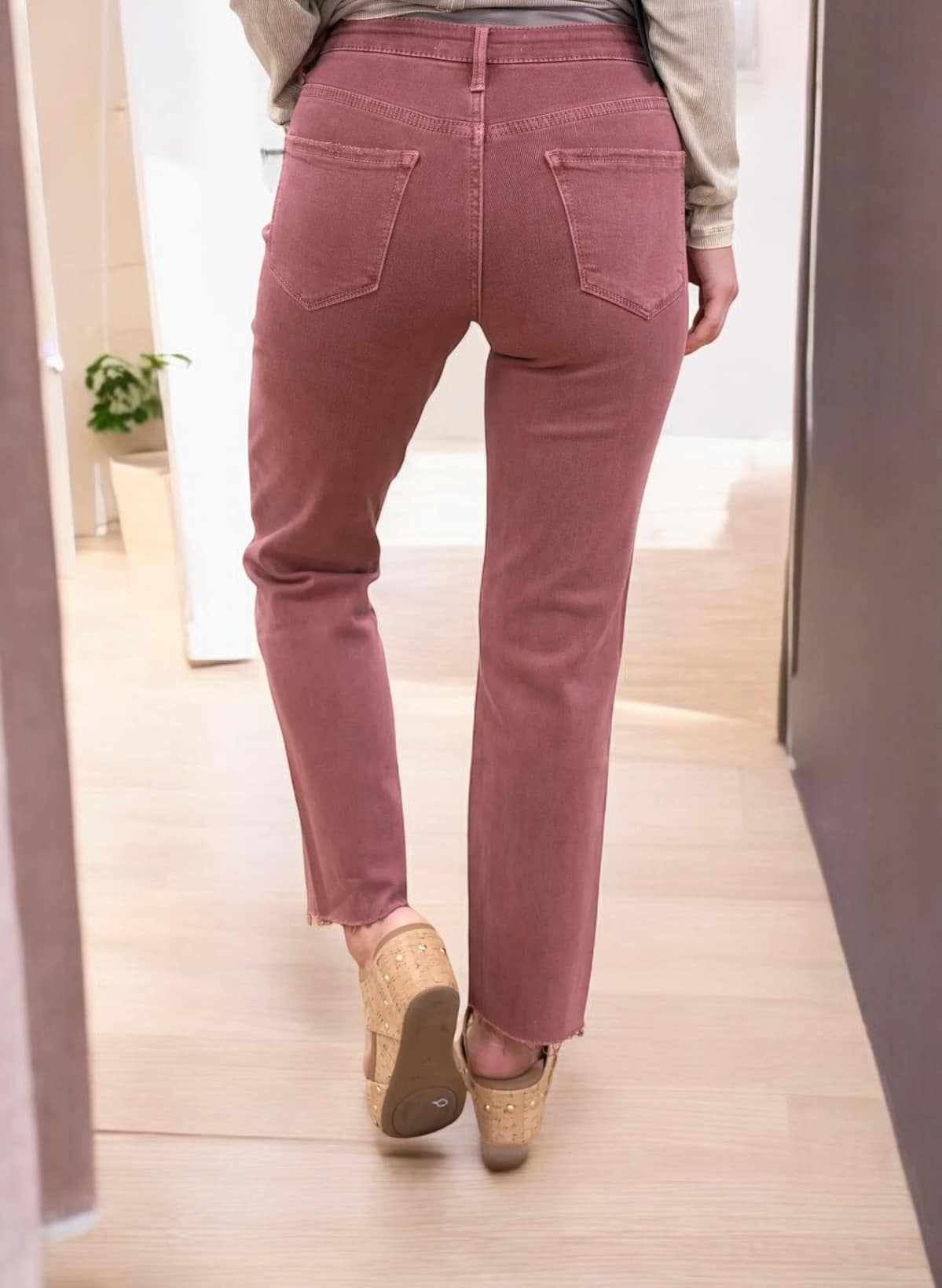 Woman wearing pink cropped straight REESE jeans with raw hem from Lovervet by Vervet, showing back view and high-rise waist.