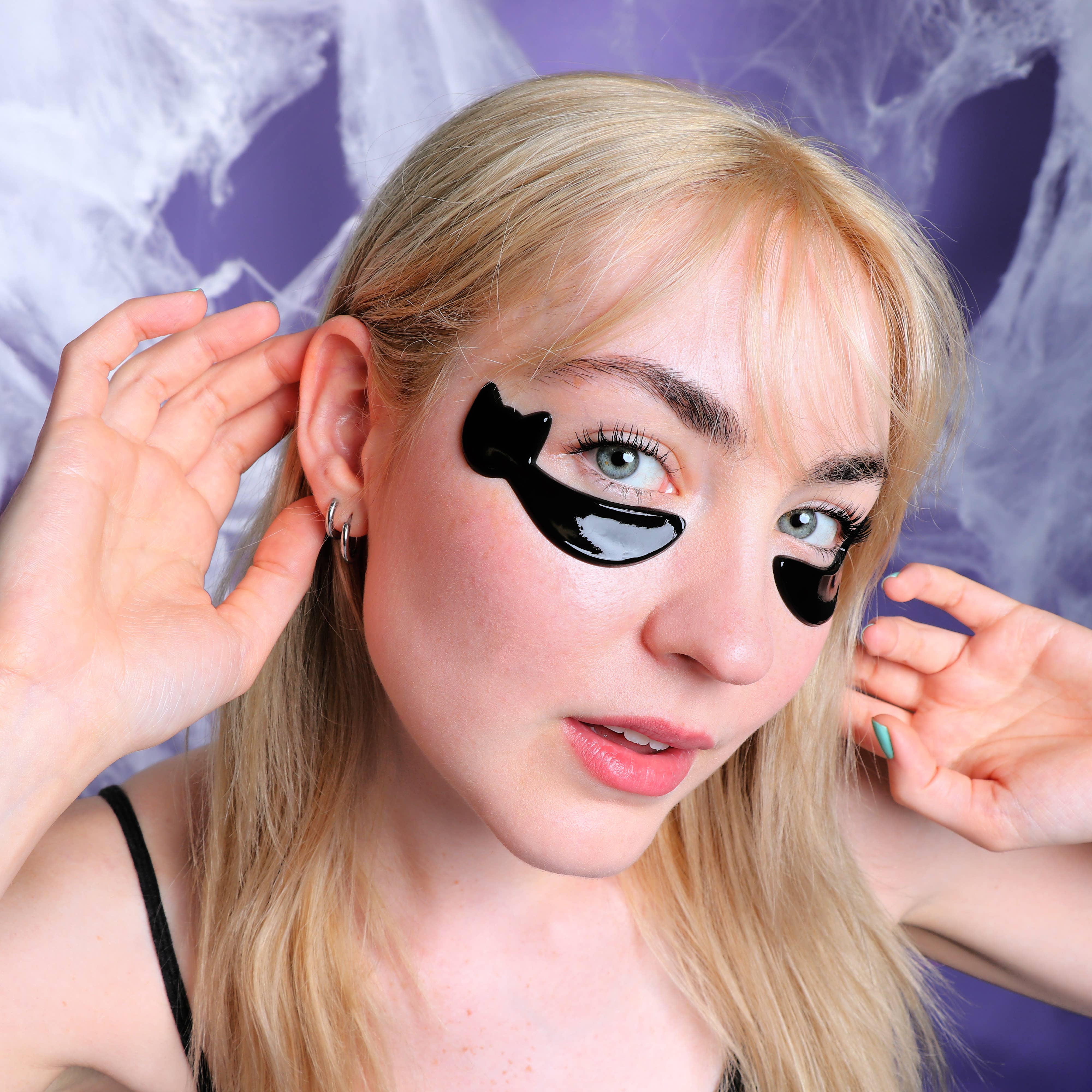 Model using Halloween Cat Eye Smoothing Undereye Masks - 6 Pairs, showcasing hydration and skincare benefits.