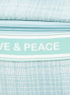 Love and Peace striped handle bag detail, featuring a textured fabric and stylish zipper design.