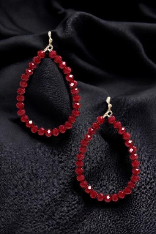 Faith Beaded Teardrop Hoop Earrings featuring red beads on a black fabric background.