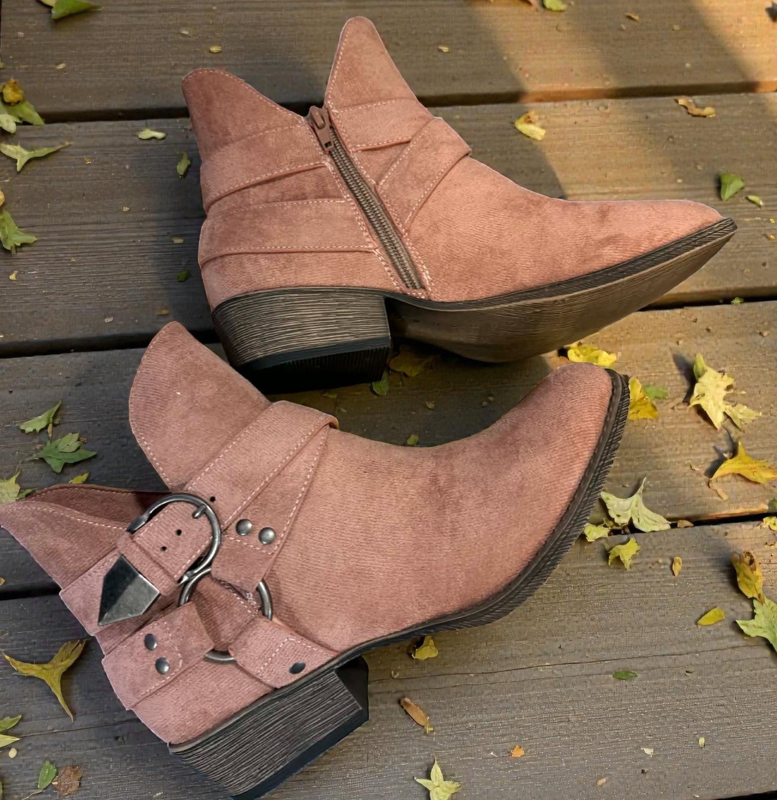 VERY G CAROLINA ANKLE BOOT in rose tan suede with side zipper and buckle detail on wooden surface with autumn leaves.