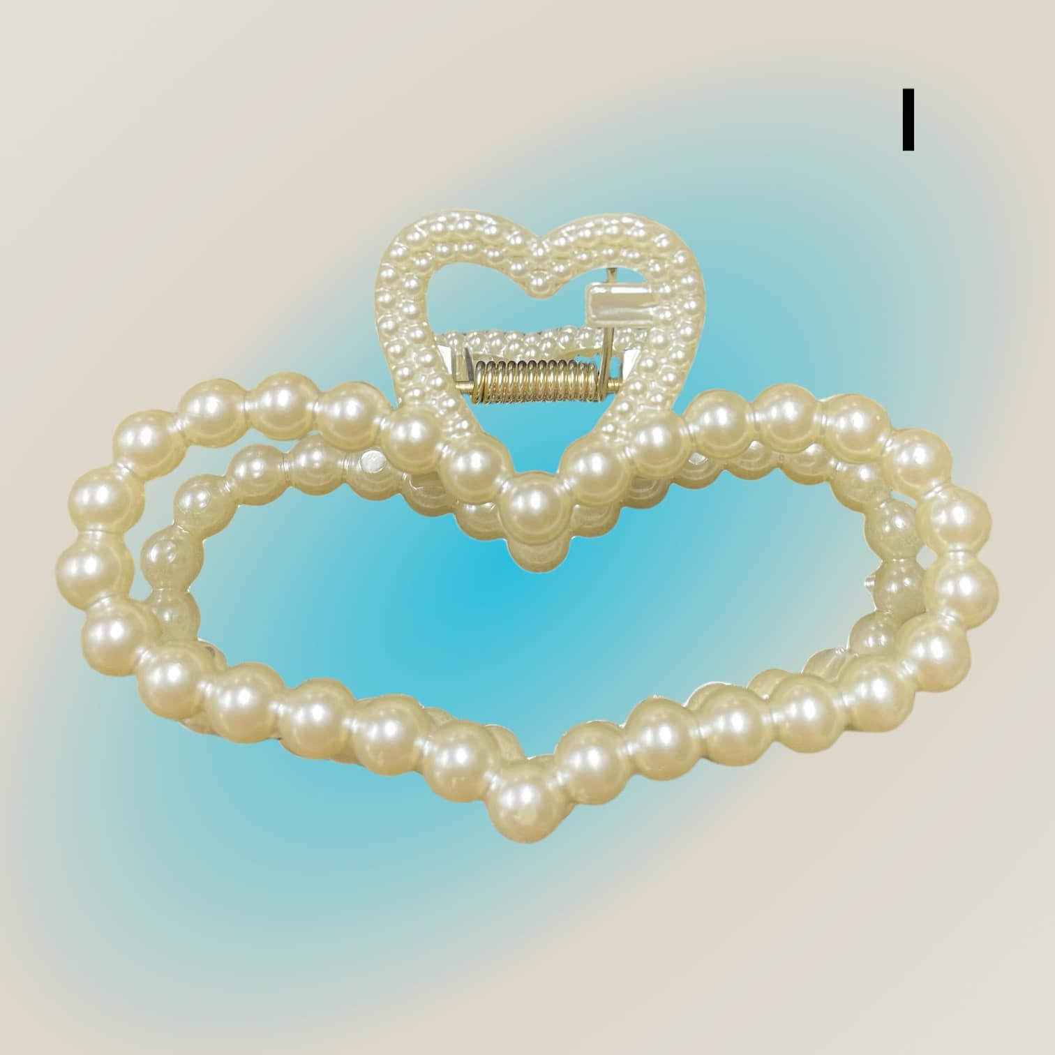 Heart-shaped Pearl Perfection Hair Clips with imitation pearl embellishments, perfect for adding elegance to any hairstyle.