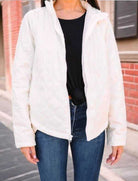 Stylish woman wearing a Wonderland puffer jacket in glazed snowflake, paired with jeans for a chic look.