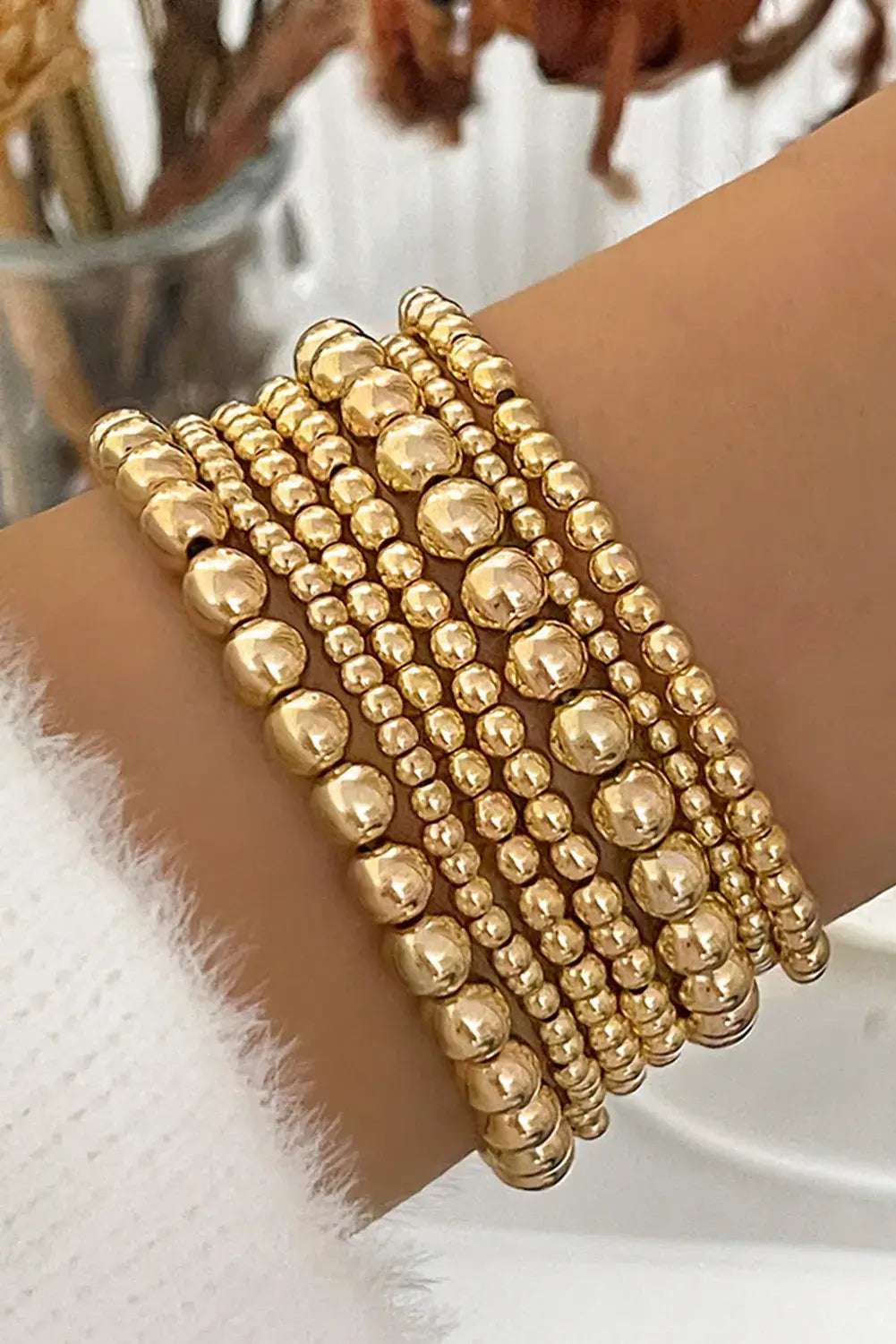 Gold tone minimalist beaded bracelet set showcasing seven elegant pieces for stylish accessories.