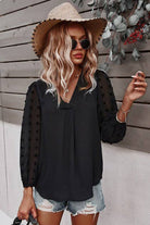 Chateau Charm Top in black worn by a woman with wavy hair, stylish hat, and sunglasses, perfect for casual outings.