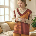 WILD HARVEST VEST - Umgee model wearing cozy brick red patchwork vest with animal print accents.