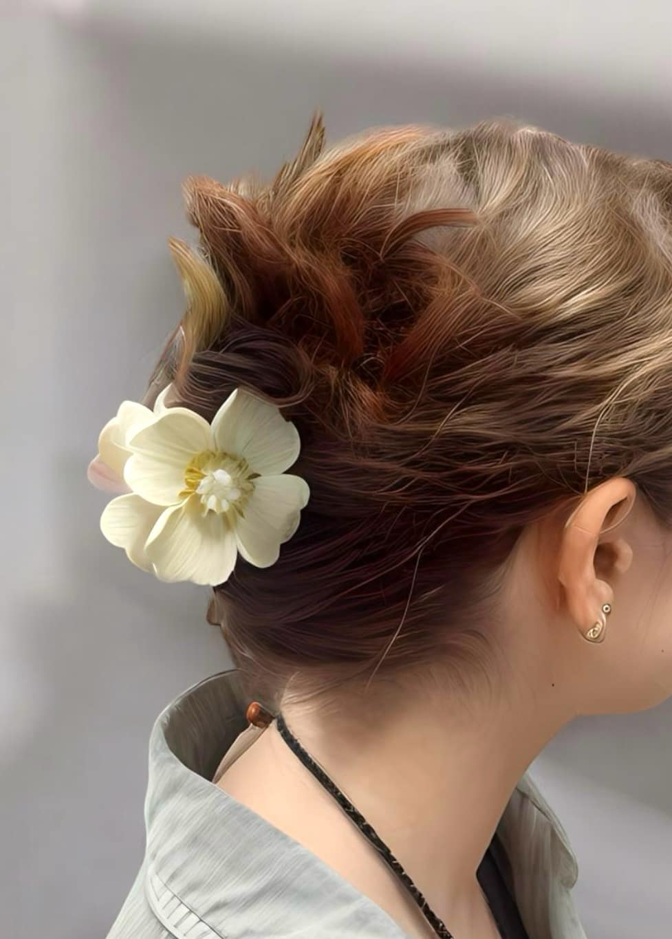 Woman wearing Petal Perfect Hair Clip in ivory, showcasing elegant floral design for a chic hairstyle, ideal for special occasions.