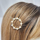 Pearl and rhinestone hair pin styled in blonde hair, showcasing elegant accessory for hair. Perfect for special occasions.