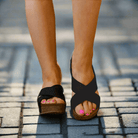 Very G Capri Wedges in Black showcased on a model walking on pavement, featuring cork sole and stylish design.
