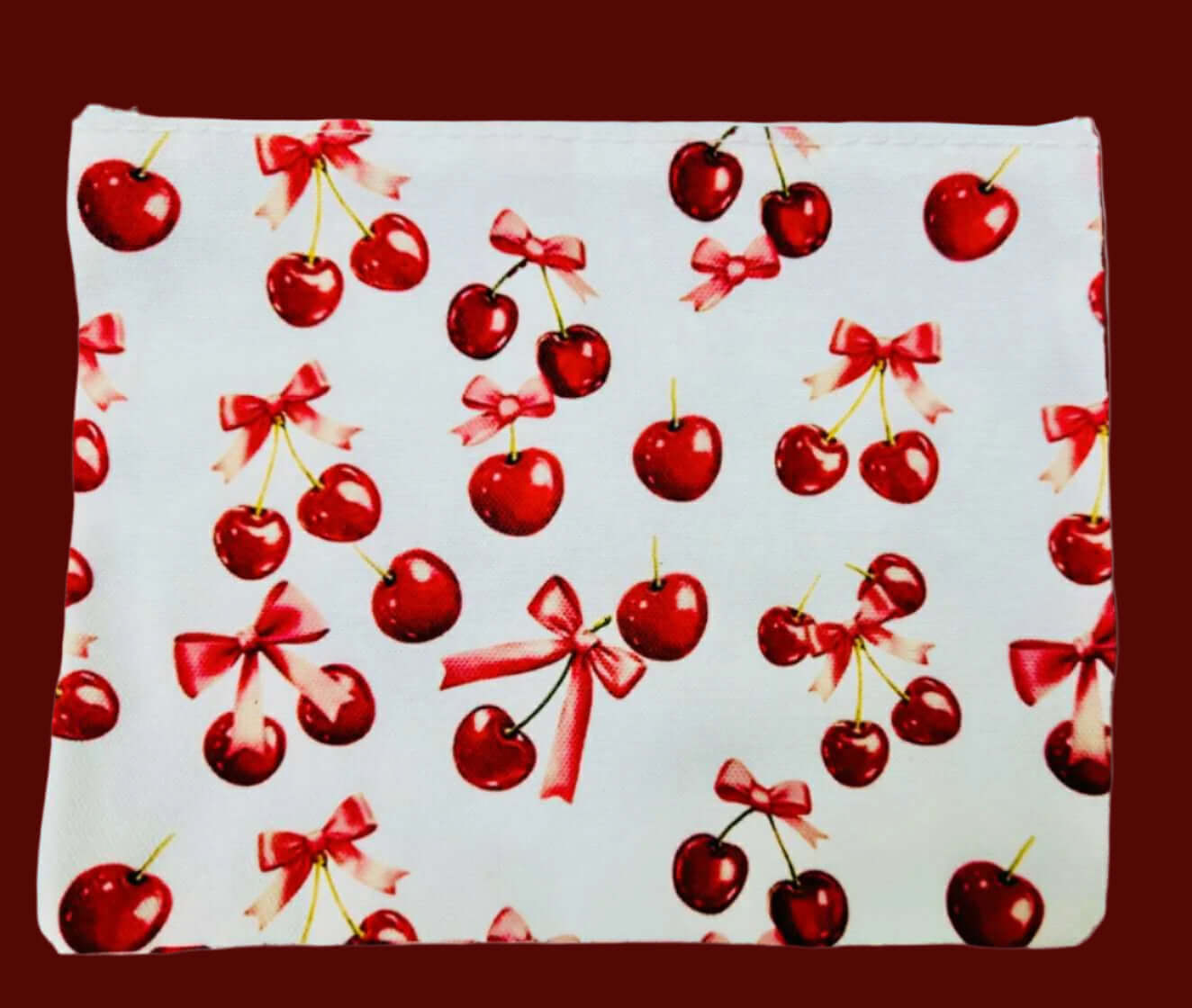 Cherry Pie Cosmetics Bag featuring vibrant cherries and bows pattern on a white canvas.