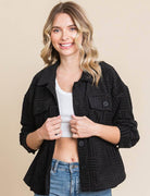Women’s black embossed shacket with button-down front, flap pockets, and relaxed fit, perfect for casual layering.