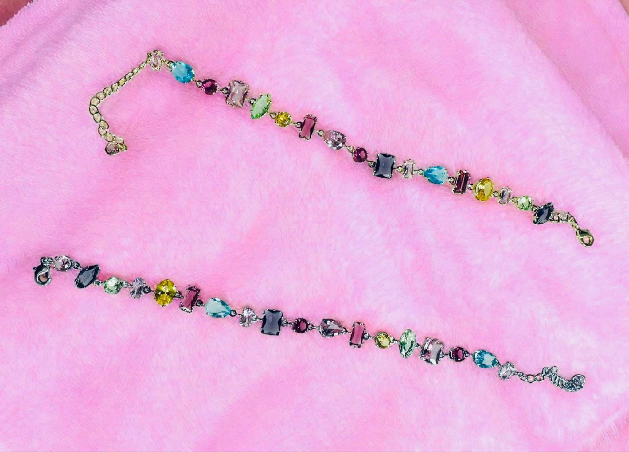 Gemstone Cascade Bracelet featuring vibrant cubic zirconia gems in gold and silver tones.