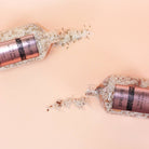 Petal-Infused Effervescent Mineral Bath Salts (Duo Pack) with lavender and rose bath salts spilling from jars.