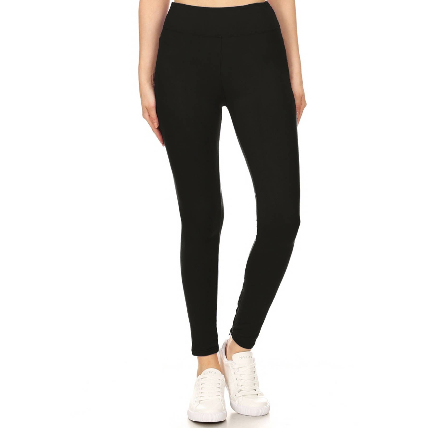 Woman wearing AWAKEN buttery soft solid black leggings with 3-inch yoga waistband and high waist, showcasing comfort and style.