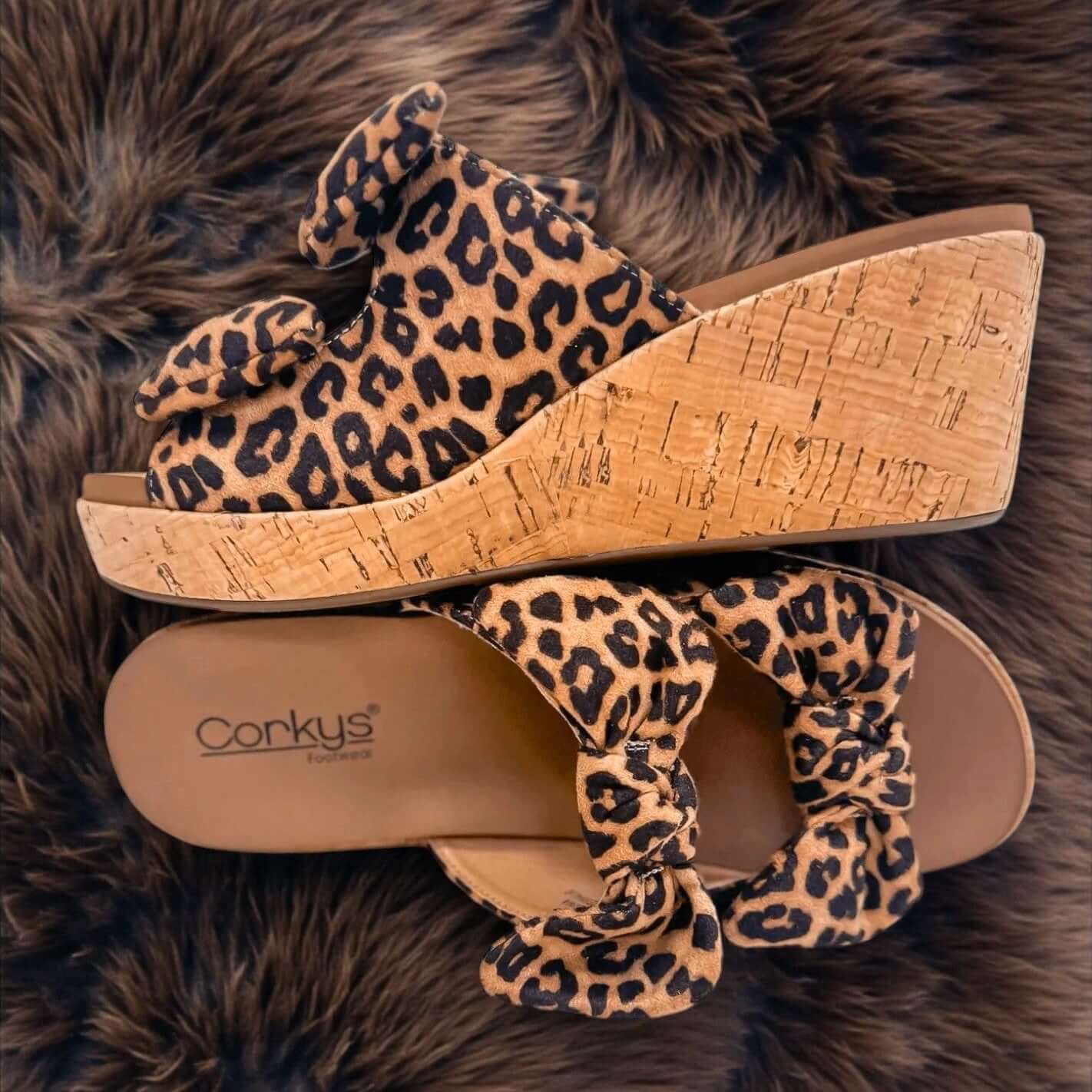 CORKYS BOWED UP WEDGES featuring leopard print, double bows, and a comfy cork wedge, perfect for stylish comfort.