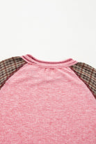 Pink Mixed Blessings Top with plaid raglan sleeves, showcasing ribbed texture and unique patchwork design.