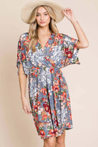 Flowy DA1475 Wrap V-Neck Midi Dress in floral design, perfect for spring and summer, worn by model with hat.