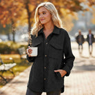WARM IMPRESSIONS BUTTON DOWN black quilted shacket worn by a woman holding a coffee cup outdoors in autumn.