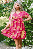 Chic summer dress with a vibrant floral print, flowy fit, and elegant empire waist, perfect for all occasions.
