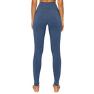 Woman wearing Pastel Denim Blue FIND YOUR BALANCE leggings with 5" yoga band, showcasing back view and fit.