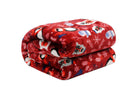 Red Christmas Cheer Plush Throw Blanket with festive prints by Kathy Ireland, folded and made of ultra-soft flannel fleece mix.