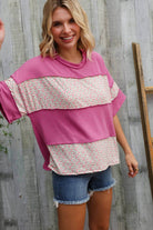 Fuchsia floral color block pullover with wavy rib knit, styled with denim shorts, perfect for a casual weekend look.