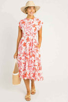 Floral midi dress by She + Sky in pink and orange, featuring pockets and a cinched waist, perfect for summer outings.
