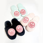 Smiley face indoor slide slippers in pink, aqua, and black for women, offering comfort and style at home.