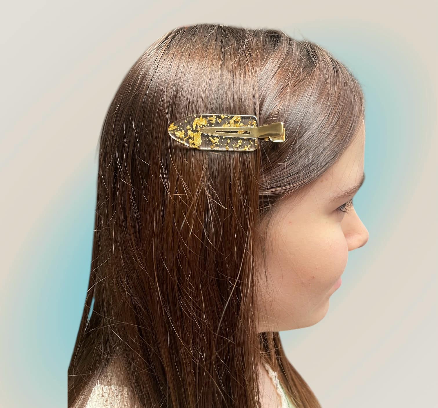Girl wearing To Have and To Hold gold hair pins, showcasing elegance and sparkle in her hair.
