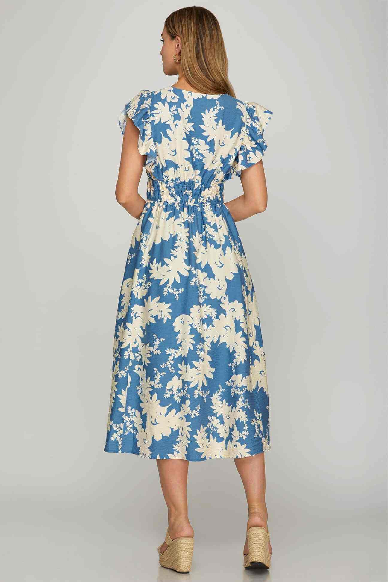 Back view of the Lakeside Serenade Dress with cream and lake blue floral print, showcasing a stylish smocked waist.