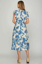 Back view of the Lakeside Serenade Dress with cream and lake blue floral print, showcasing a stylish smocked waist.