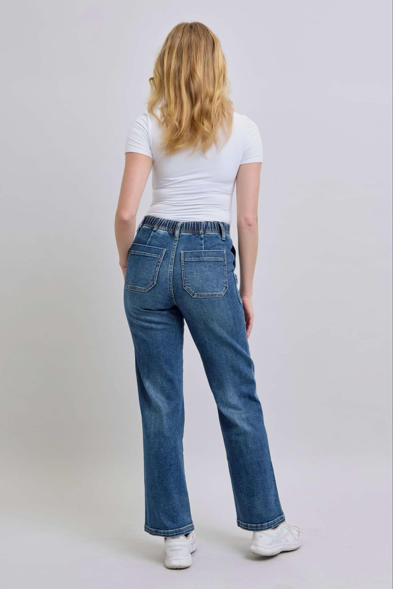 Model wearing JUDY BLUE Sophia Jeans with high waist and wide leg design, showcasing back view.