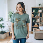 Woman wearing the TAKE FLIGHT TEE - The Lattimore Claim with detailed waterfowl graphic in a nature-inspired setting.