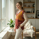 Model wearing WILD HARVEST VEST - Umgee in a cozy setting, showcasing the brick red patchwork design.