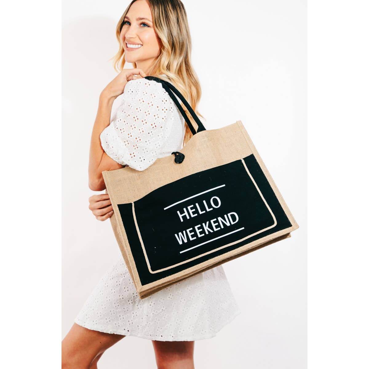 Smiling woman holding a Hello Weekend burlap tote bag made of 100% polyester, ideal for weekend outings.