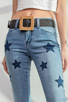 Star Walk Jeans by Easel with star patch details and slim fit design modeled with a woven belt.