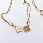 MONOGRAM MOMENTS NECKLACE featuring a gold floral pendant and initial 'L' on a delicate chain.