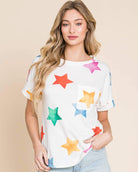 Model wearing a colorful star print t-shirt paired with denim shorts, showcasing a relaxed, casual style.
