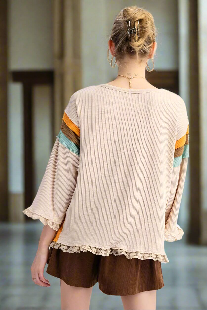 Back view of the KEEP THE FAITH top by Easel showcasing striped sleeves and lace hem detailing.