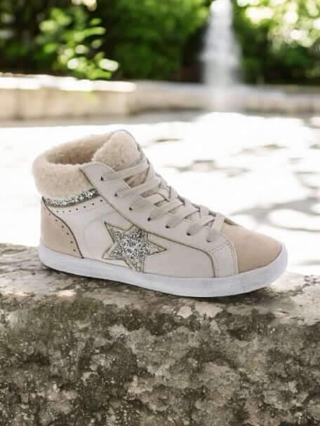 Very G Star Bright Sneakers in cream with glitter star and sherpa accents on a stone surface.