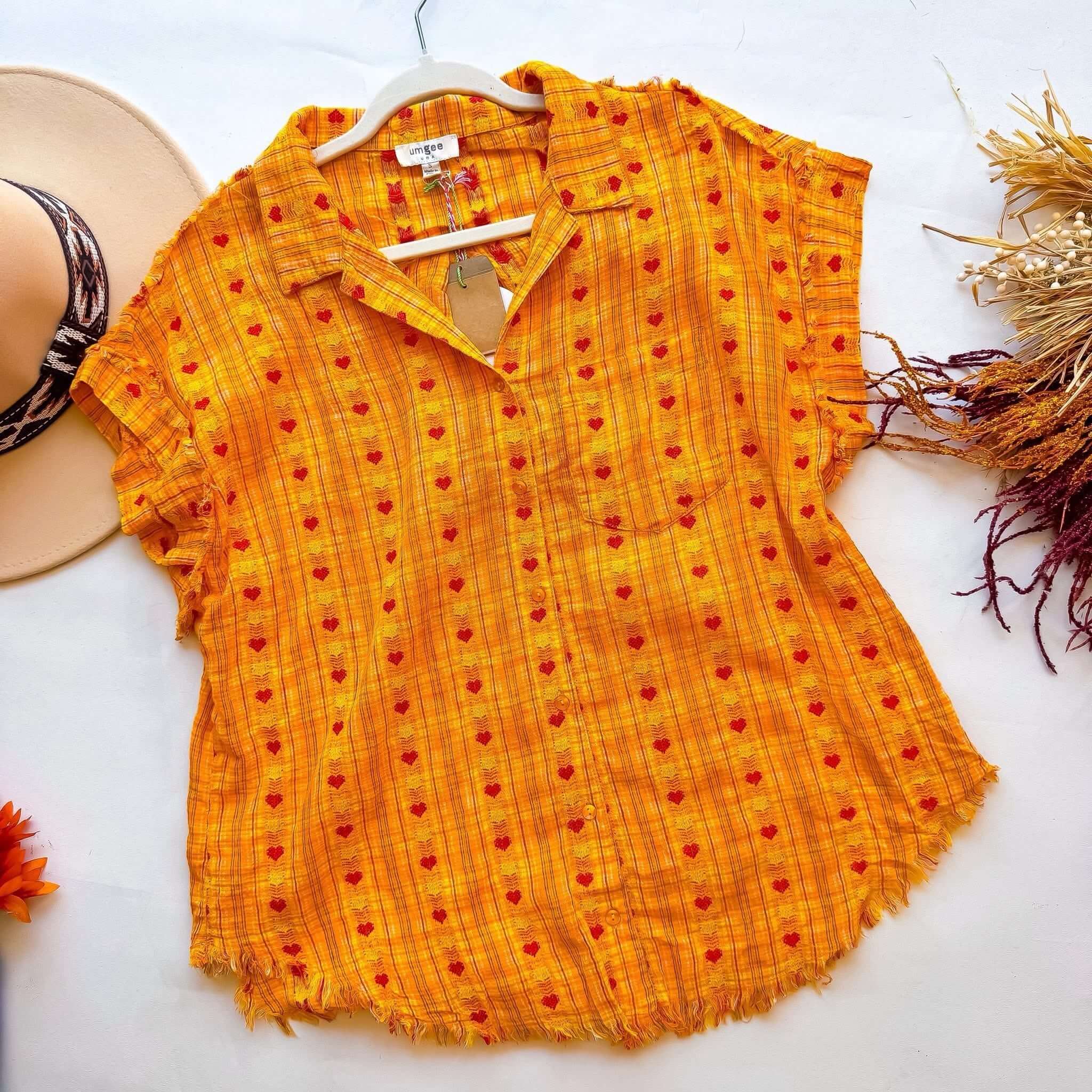 Hello Happiness Top by Umgee in sunny yellow with heart motifs and frayed details, perfect for a cheerful outfit.