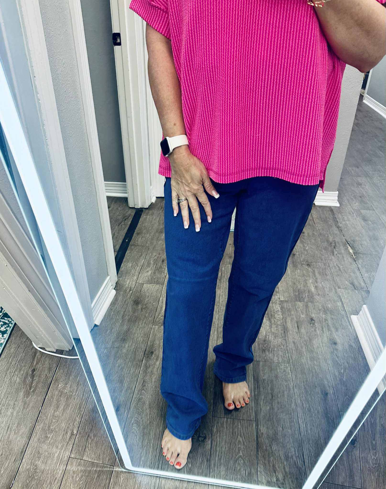 Model wearing LILA HIGH RISE DAD JEANS with a pink top, showcasing a stylish casual look in a full-length mirror.