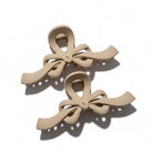 RIBBON REVIVAL HAIR CLIP (7 colors) in matte beige, featuring elegant bow design and strong grip for stylish hair styling.