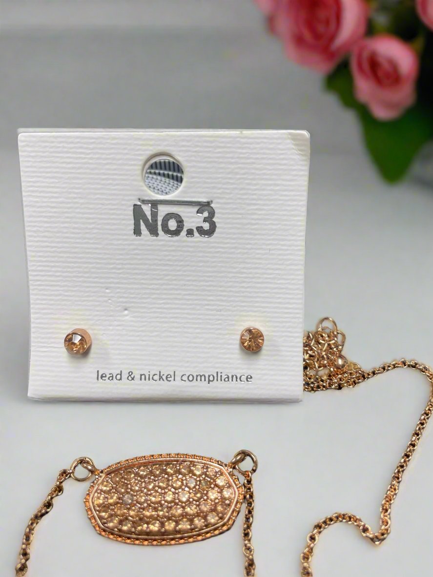 Druzy oval pendant necklace and matching stud earrings in elegant rose gold.