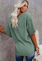 Woman wearing the Carefree Mode Top in jade green, showcasing relaxed style and modern details from Teal Tiger Boutique.