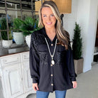 Model wearing CITY LIGHTS TOP, a black corded shacket with sequin patch chest pockets, showcasing chic style.