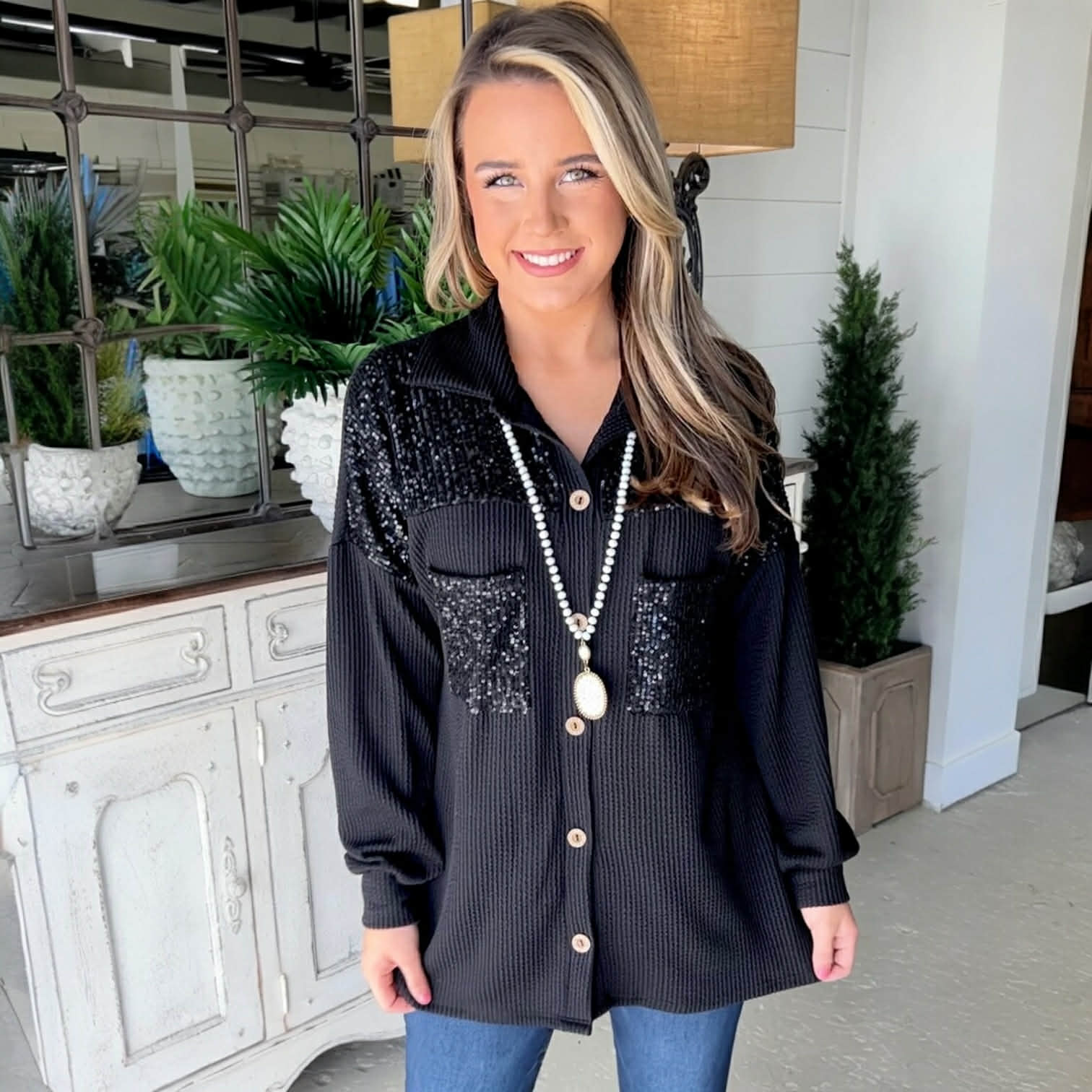 Model wearing CITY LIGHTS TOP, a black corded shacket with sequin patch chest pockets, showcasing chic style.