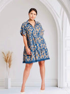 Umgee PACIFIC MIRAGE DRESS in slate blue and tan with animal print and frayed hem on model.