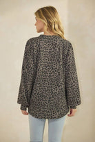 Model wearing ET7975-14 LONG SLEEVE V NECK ANIMAL URBAN RIB TOP in a leopard print from the back.